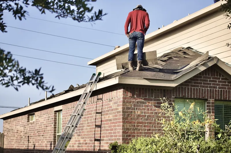 Professional roofer working on a residential roof in Seneca